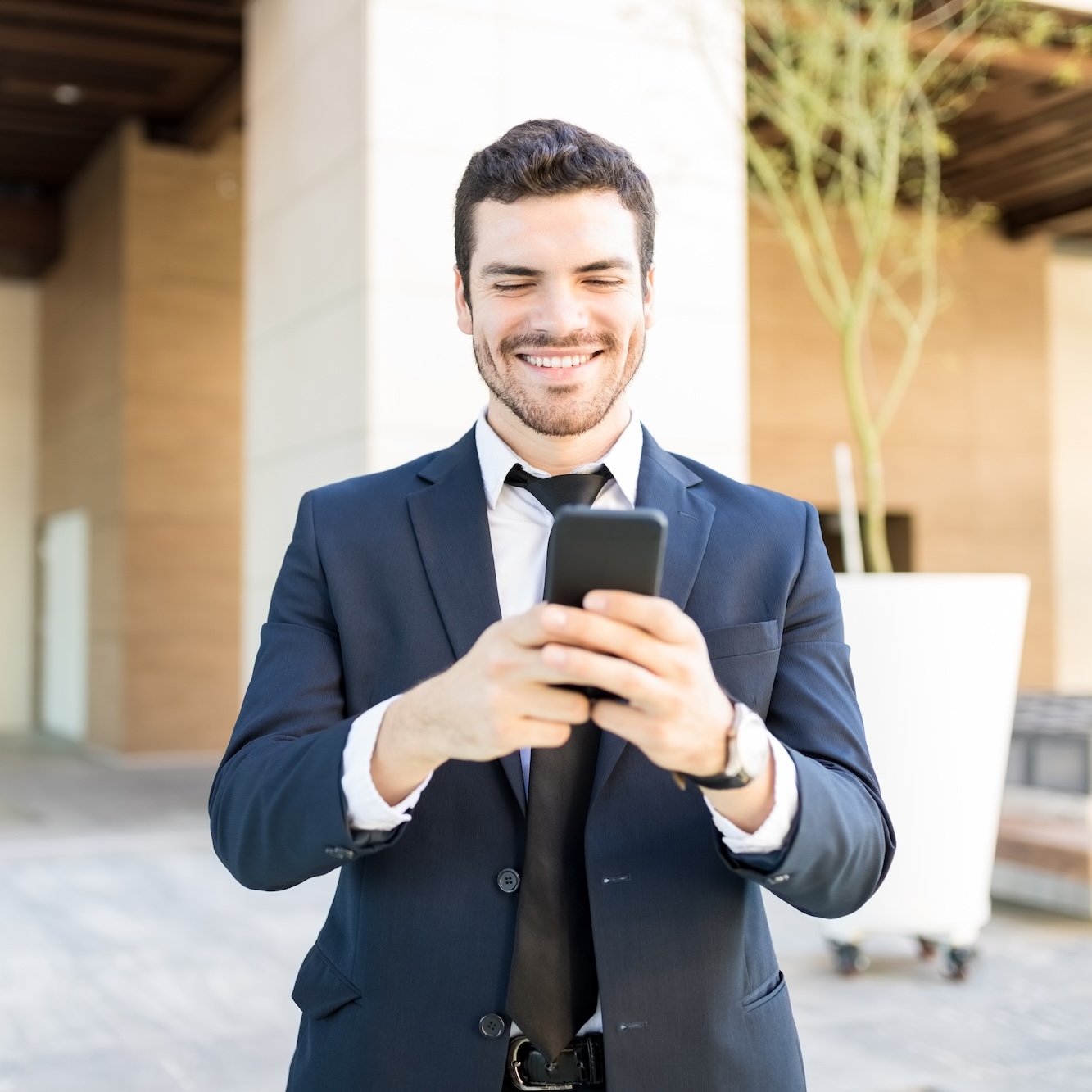 Real estate agent using a phone, illustrating the ease of creating landing pages